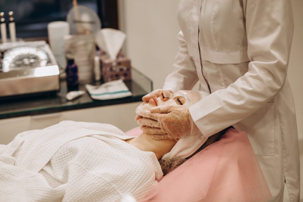 Cliente recibiendo un masaje relajante como parte de un tratamiento estético con cosmética termal en un spa.